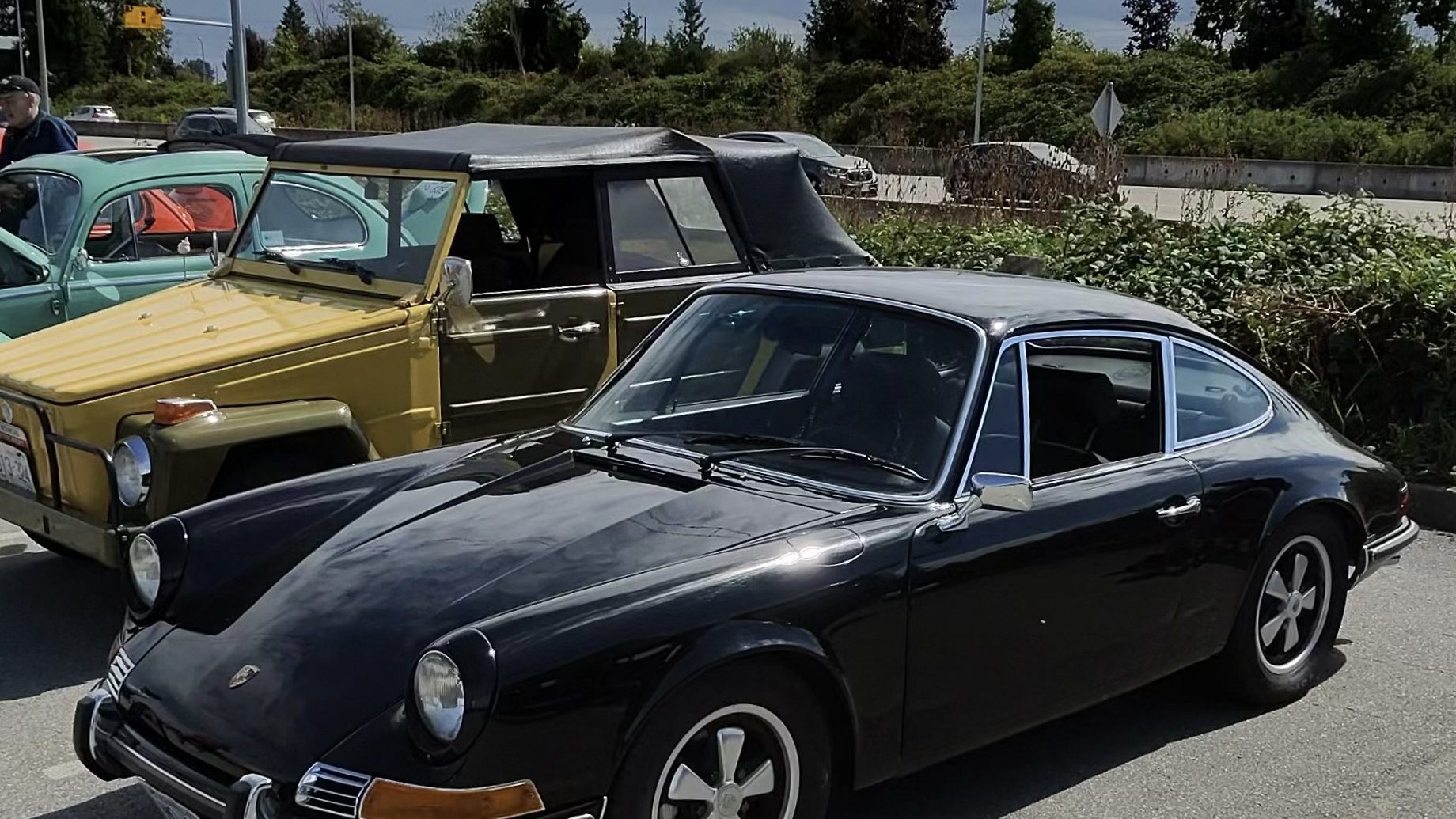 Air-cooled Porsche 911 parked among classic cars at a cars and coffee morning